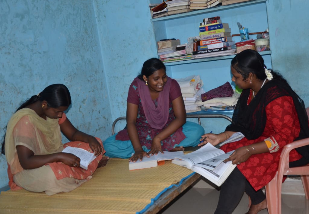 Ramya studies with two of her younger sisters. Excelling Amidst Challenges